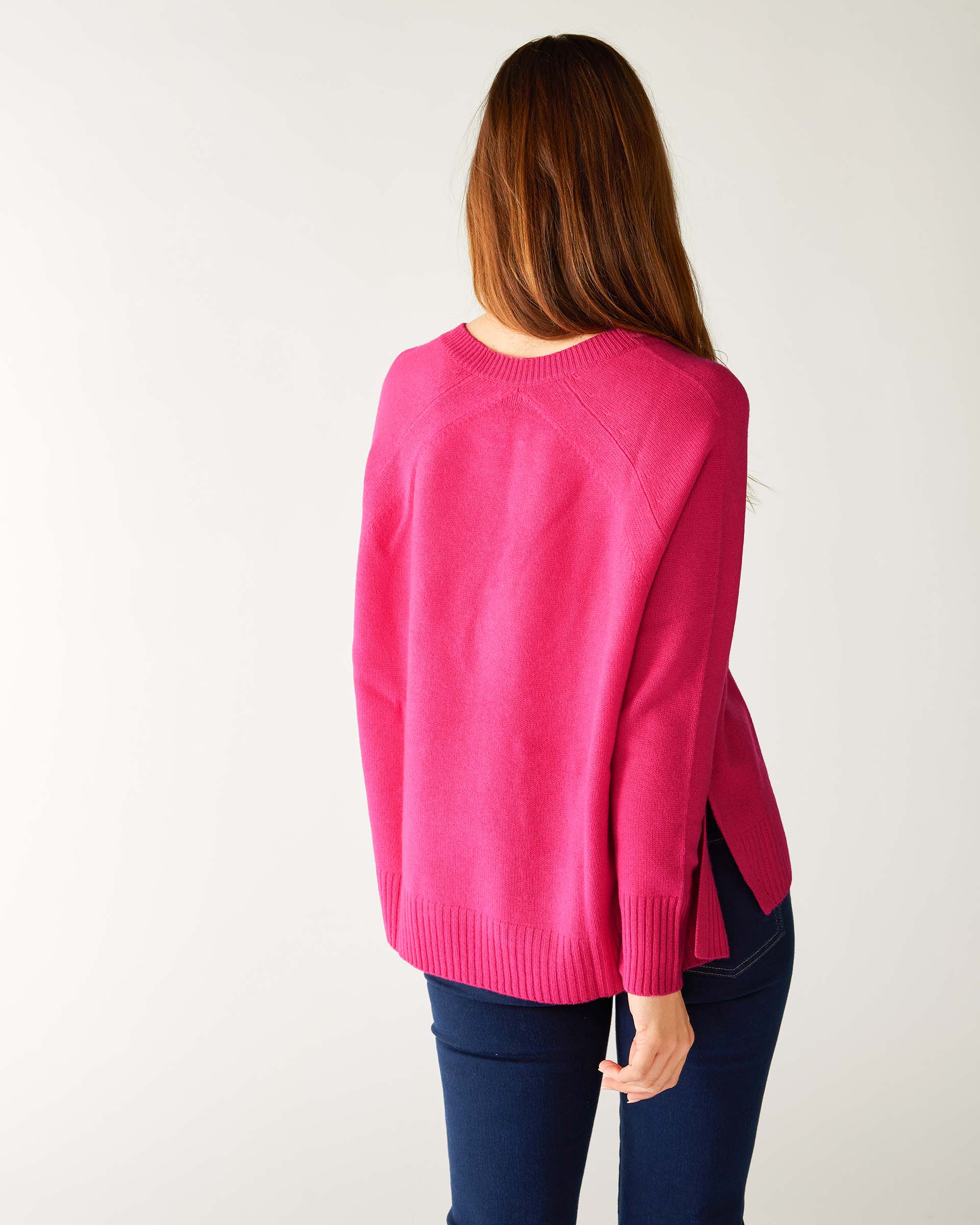 rear view of woman wearing mersea banff cashmere sweater in hot magenta