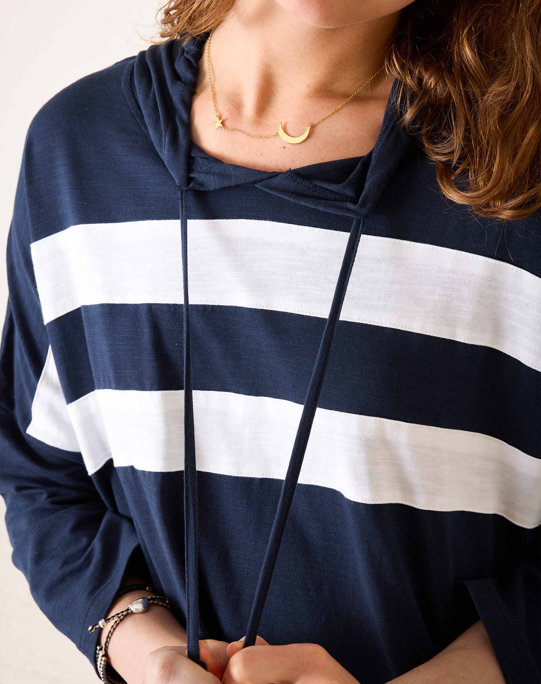 Navy and white striped hoodie worn by a person