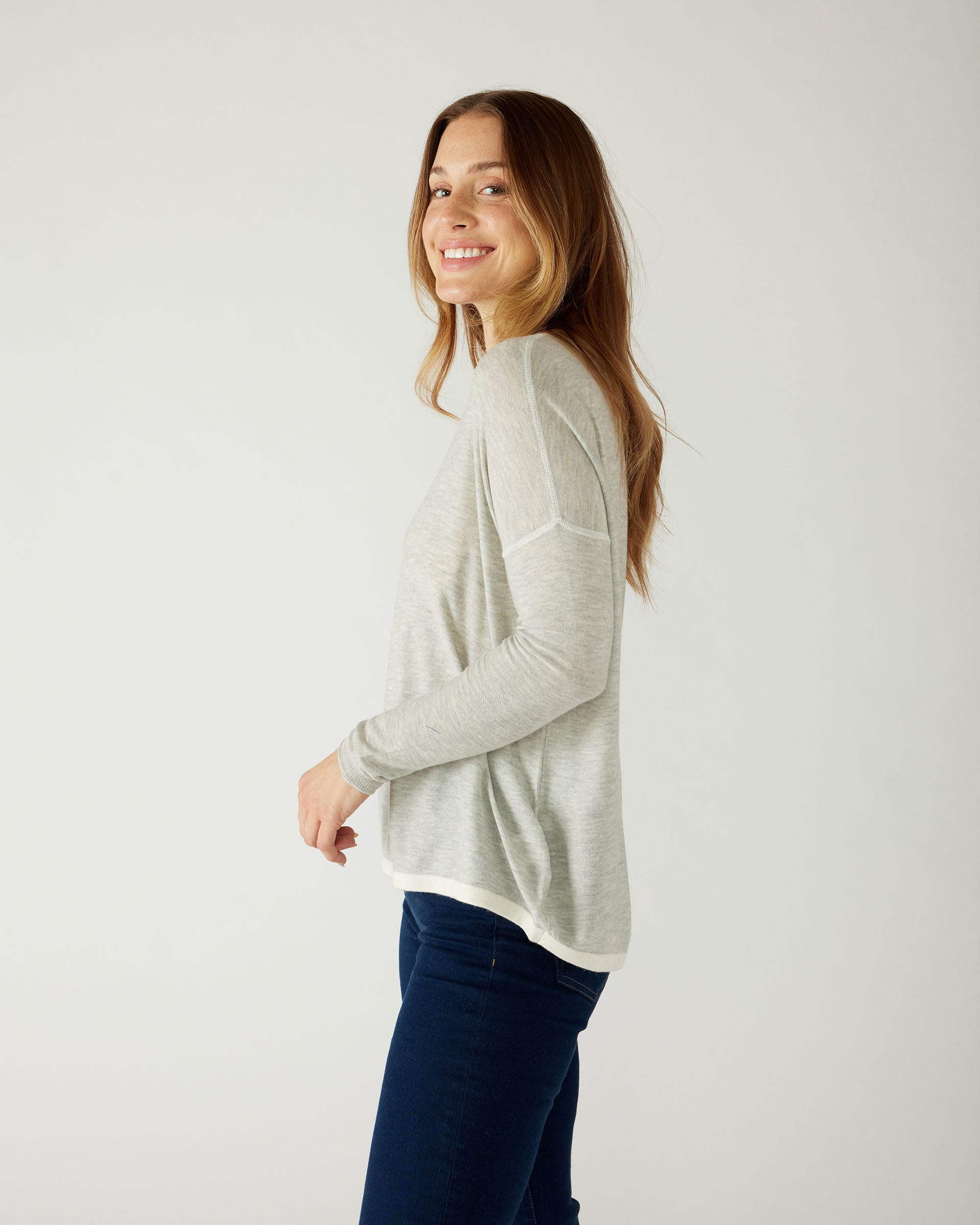 profile of woman wearing mersea saltwash sweater in grey