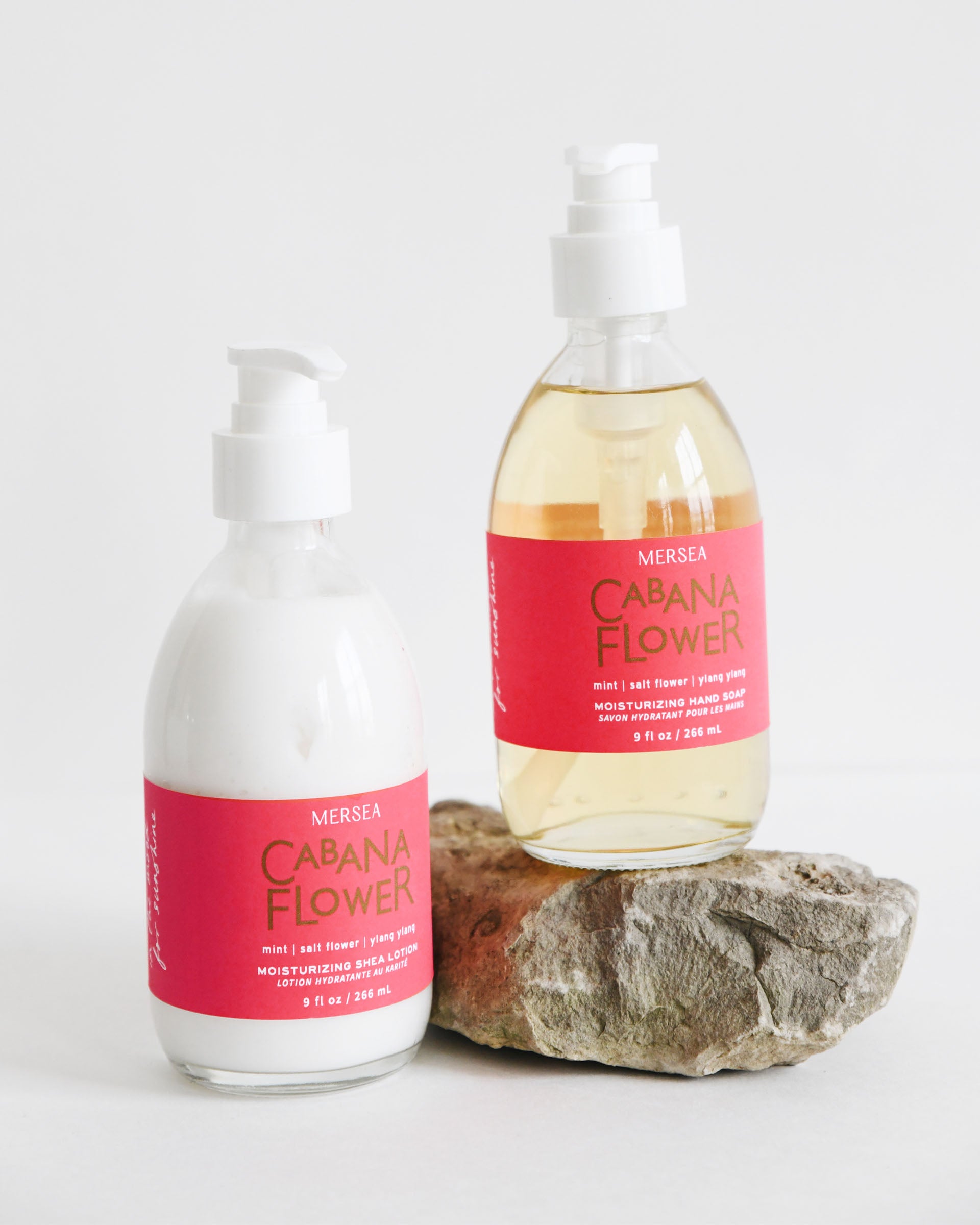 cabana flower shea lotion and hand soap sitting on a rock