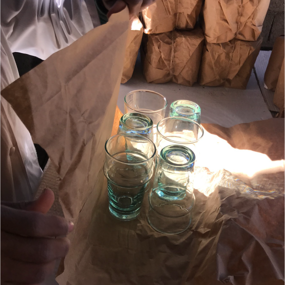Candle Glasses Being Wrapped in Paper at Factory