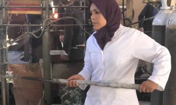 Woman Crafting Glass in Factory