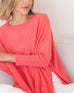 Women's Oversized Crewneck Knit Sweater in Coral Pink Chest View of Side Slits Sitting
