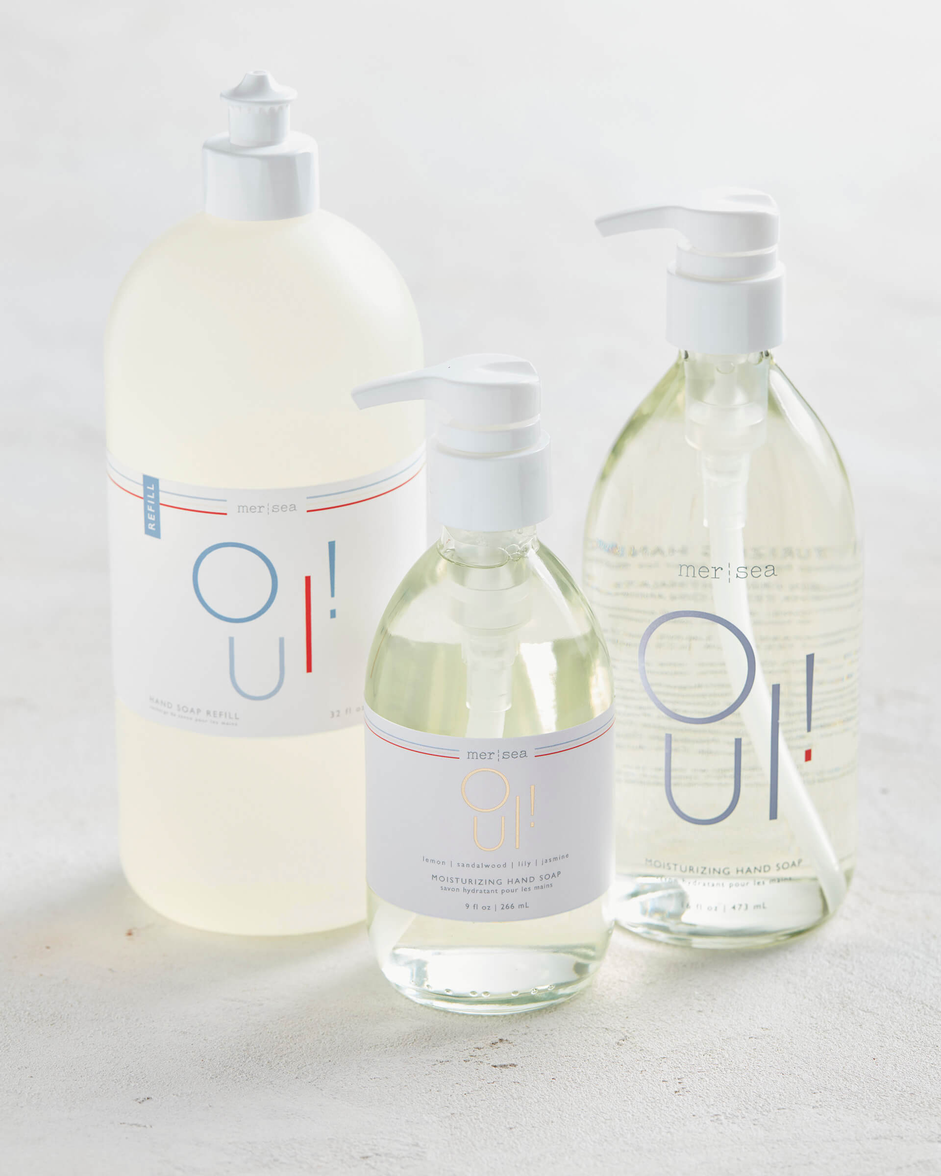 OUI! scented large liquid hand soap, liquid hand soap, and refill bottle sitting on white background