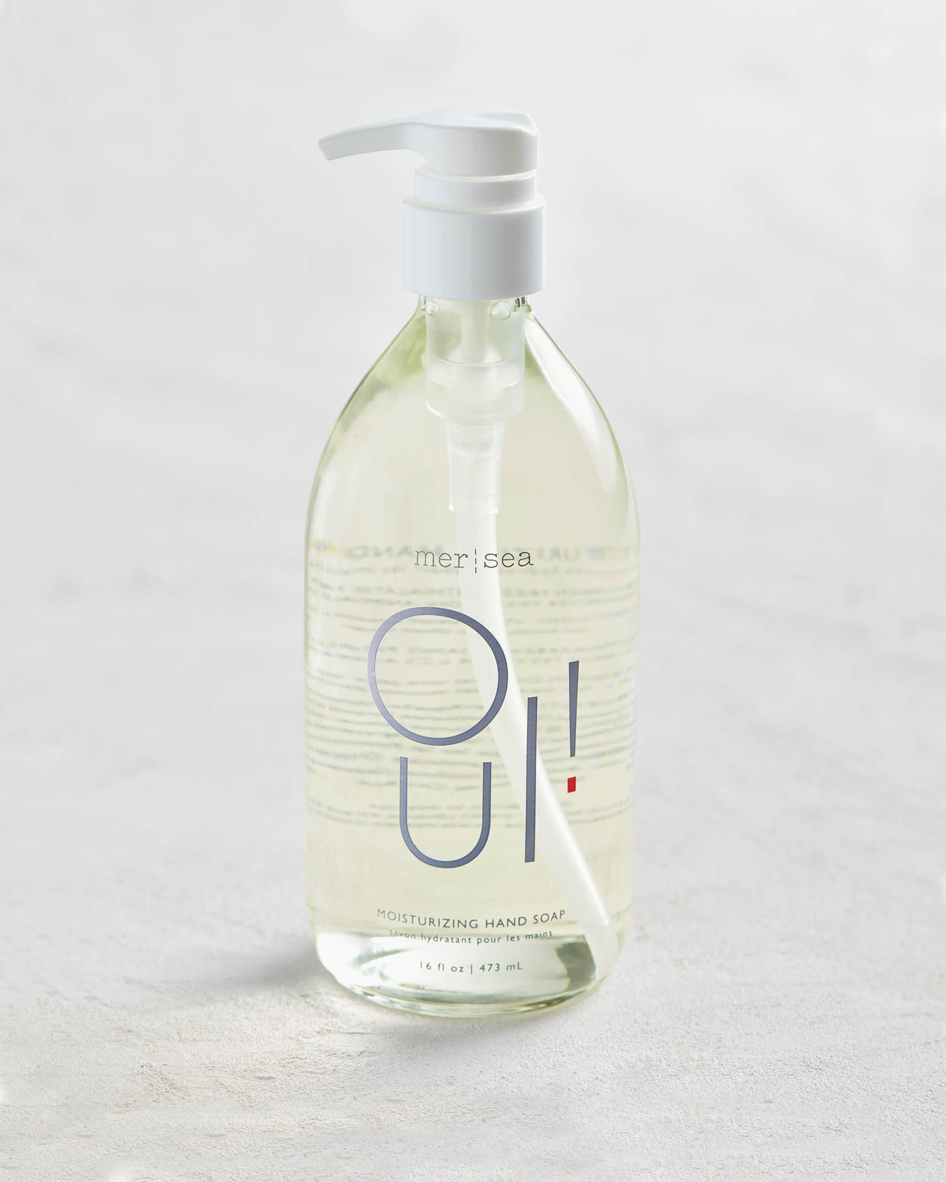 large OUI! liquid hand soap sitting on a white background