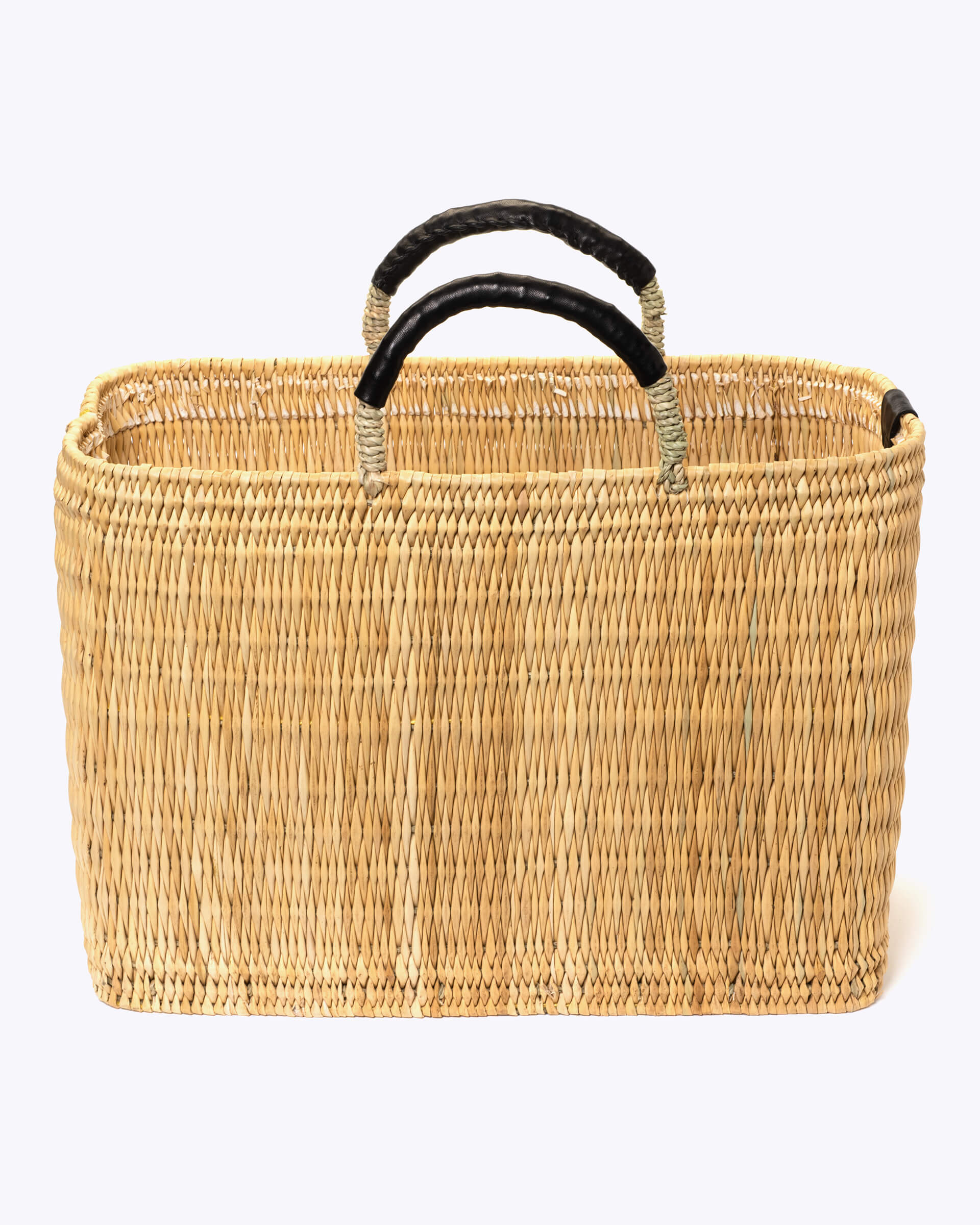 large straw basket wrapped with black leather handle on a white background 