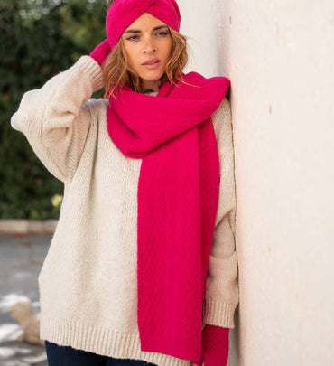 female wearing pink fuzzy headband with matching fingerless gloves and scarf over white sweater