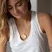 woman wearing mersea colab Aquarius zodiac pendant