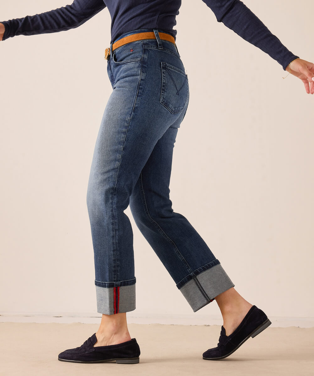 Blue denim crop jeans with cuffed hems and a slim fit.