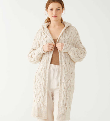 female wearing bone hooded duster over bone twill pants and brown tank on a white background