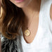 woman wearing mersea colab pisces zodiac pendant with chain