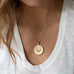 woman wearing mersea colab taurus zodiac pendant