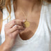 woman wearing mersea colab taurus zodiac pendant