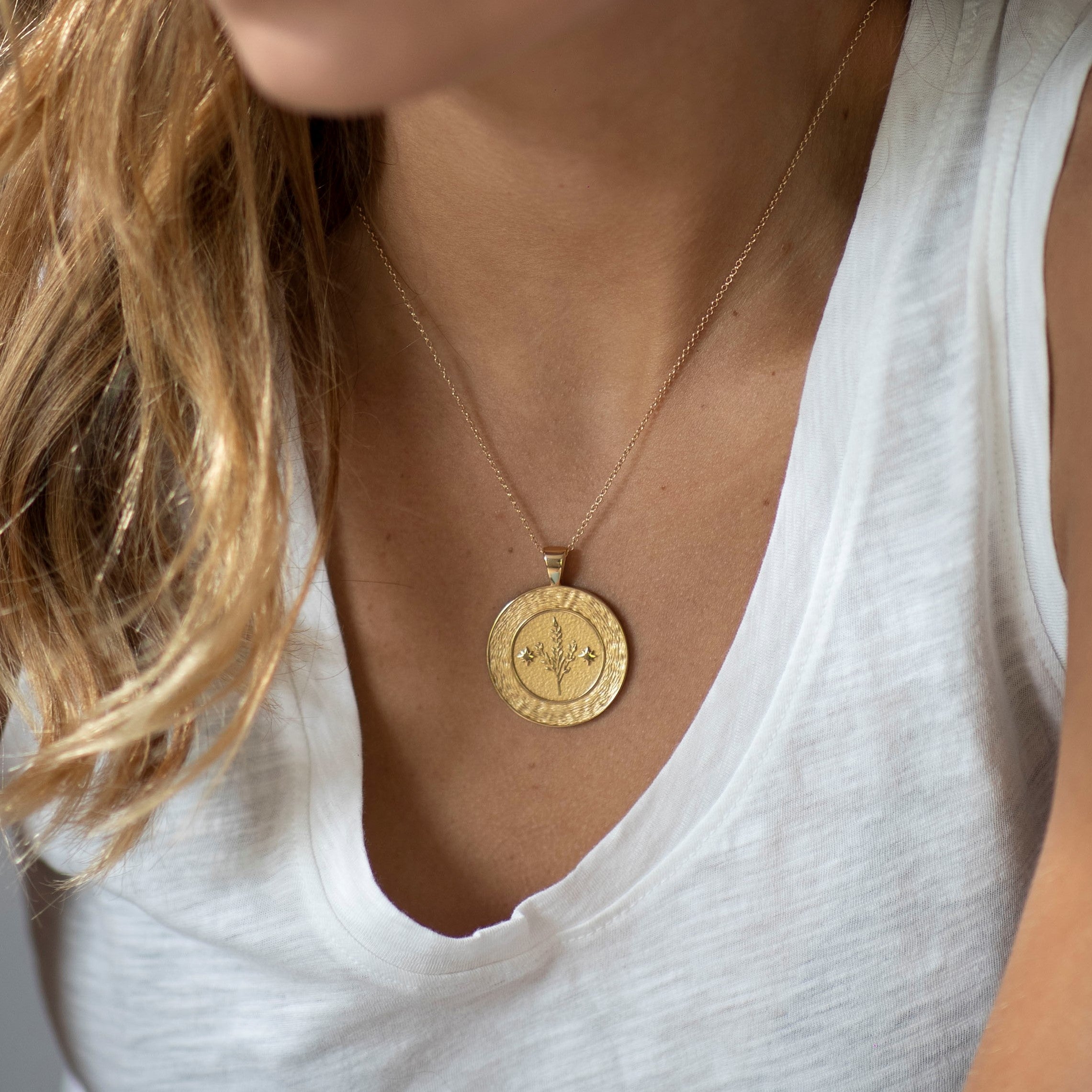 woman wearing mersea colab virgo zodiac pendant