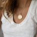 woman wearing mersea colab gemini zodiac pendant with chain