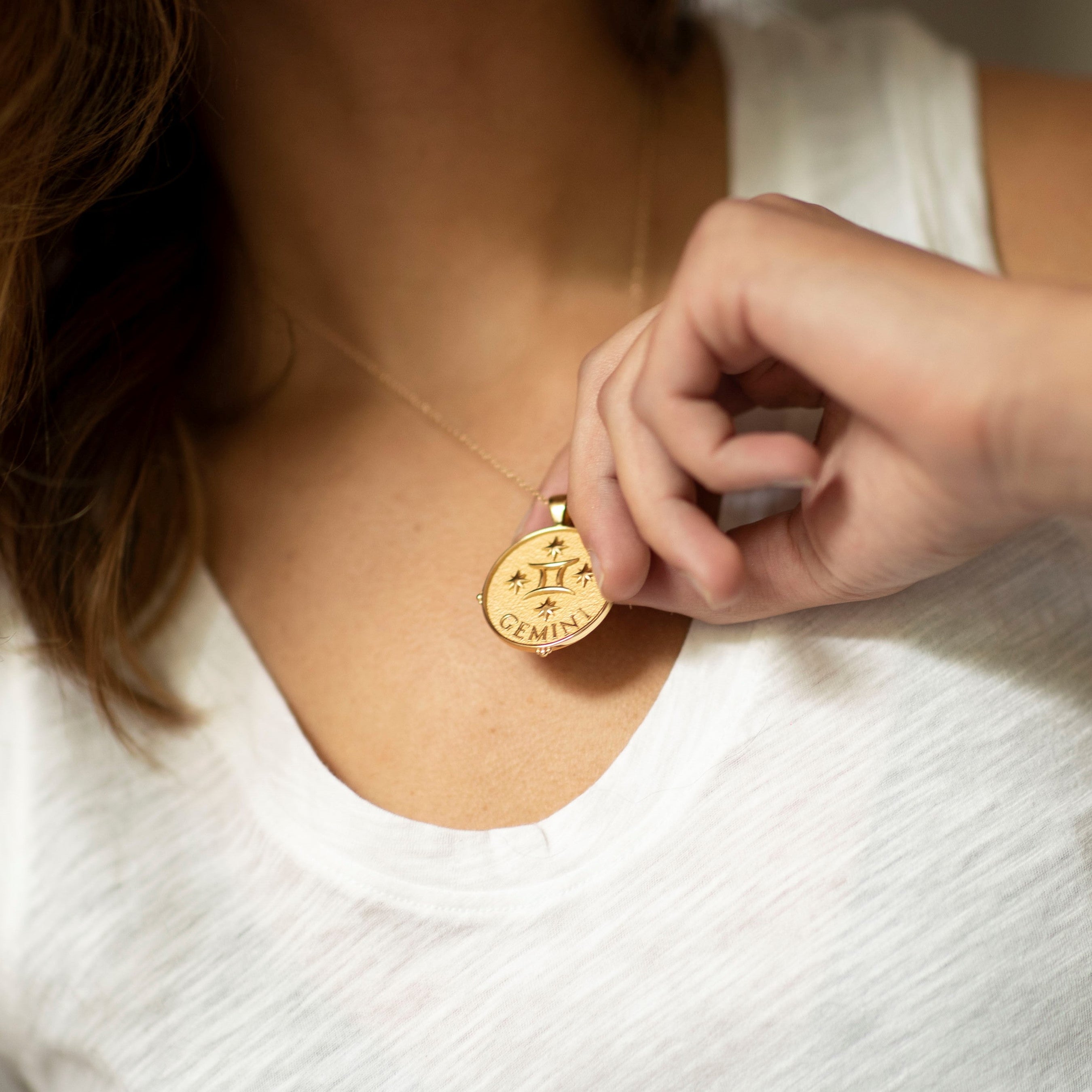 woman wearing mersea colab gemini zodiac pendant with chain