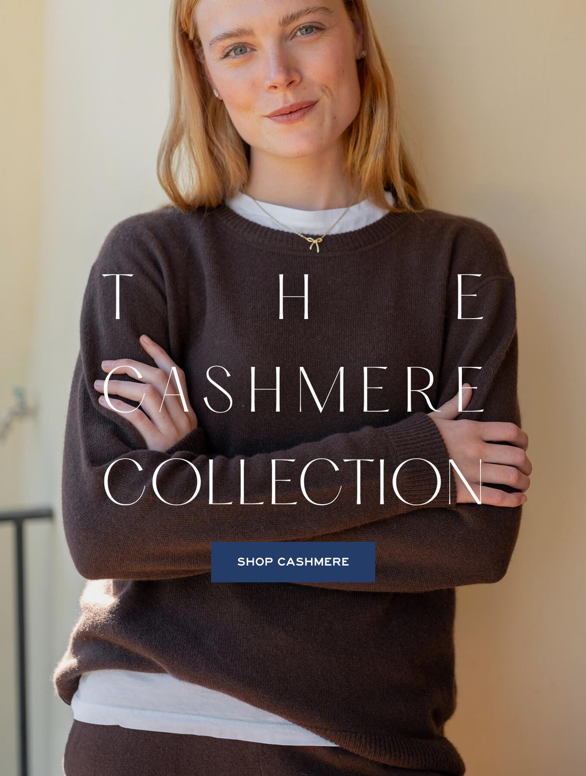 A woman wearing a warm brown cashmere sweater and a white undershirt. Text: THE CASHMERE COLLECTION. Button text: SHOP CASHMERE
