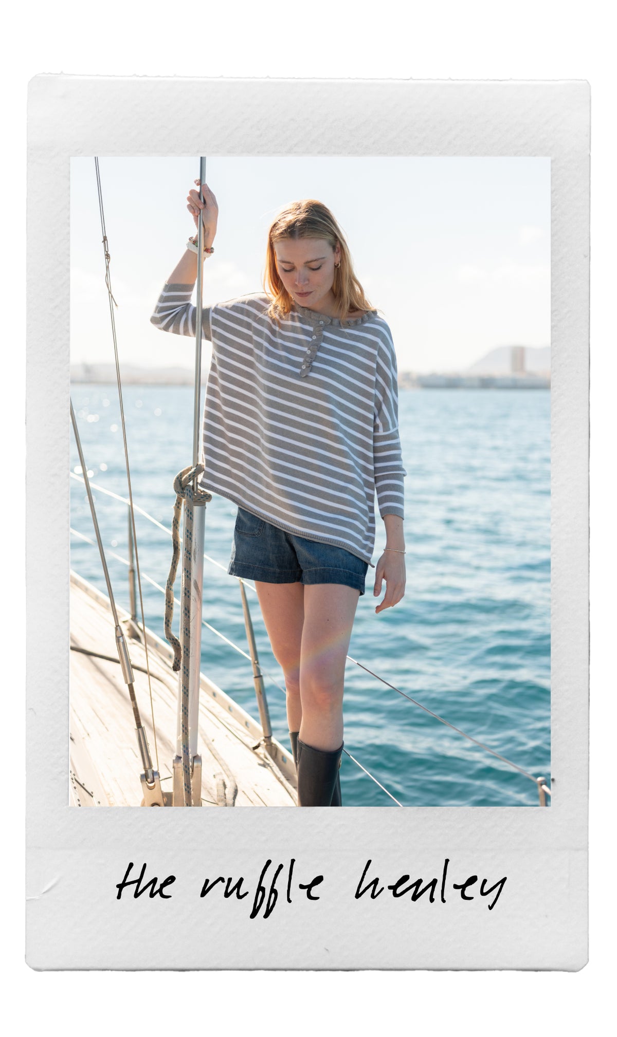 Blue and white striped jersey knit Henley top with a relaxed fit.