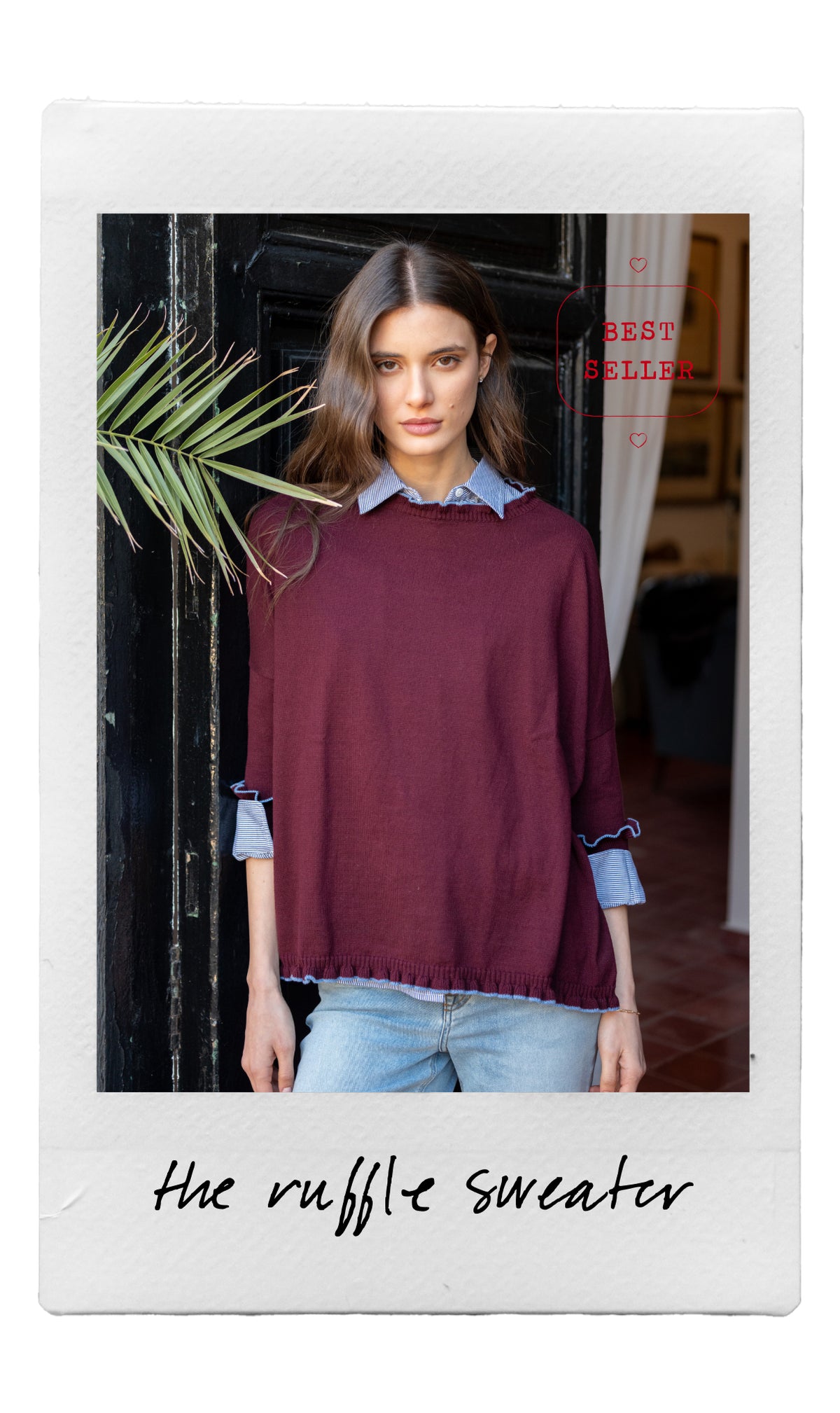 Deep burgundy oversized knit sweater with a ruffled hem and layered blue striped shirt collar detail.