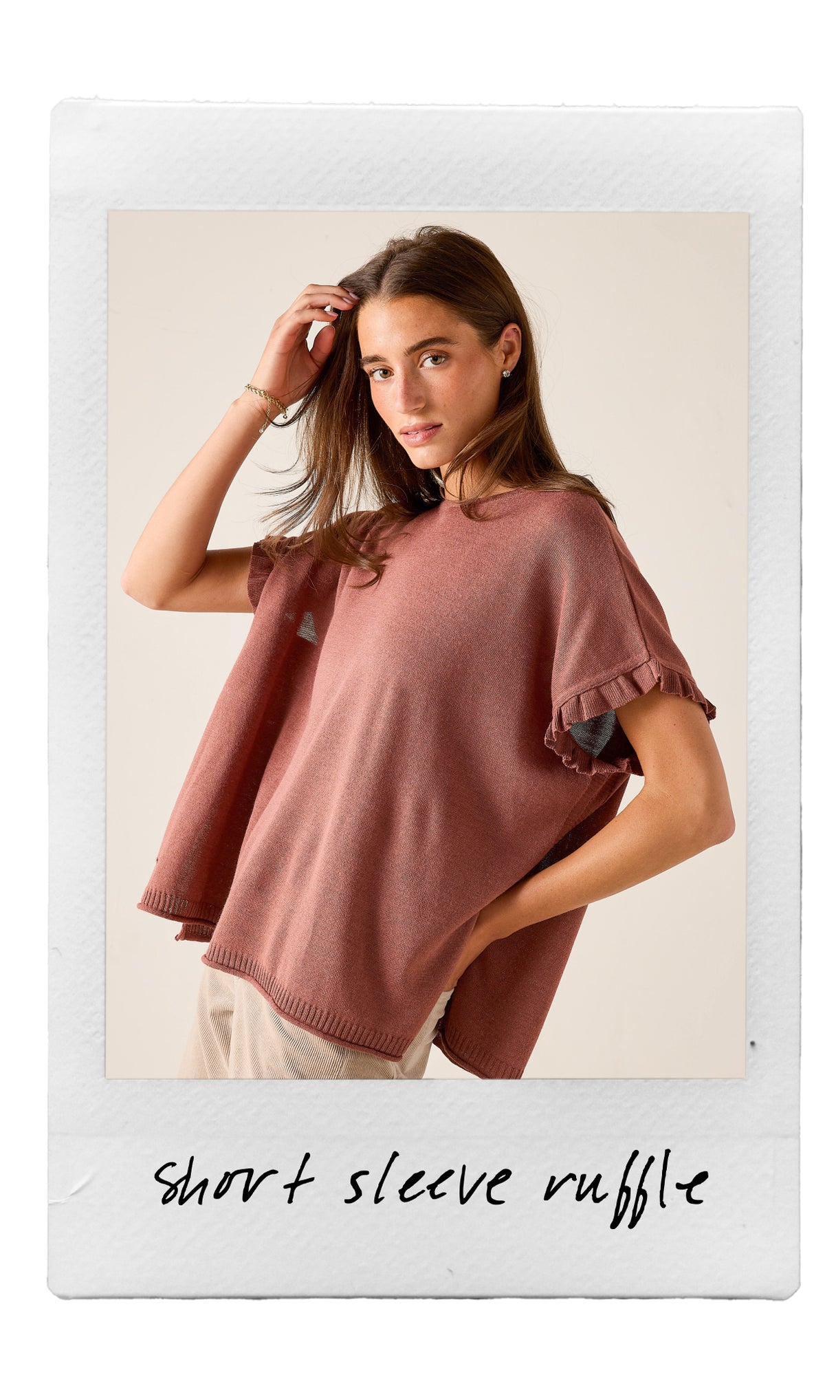 Terracotta pink knit top with ruffled short sleeves and a relaxed fit.