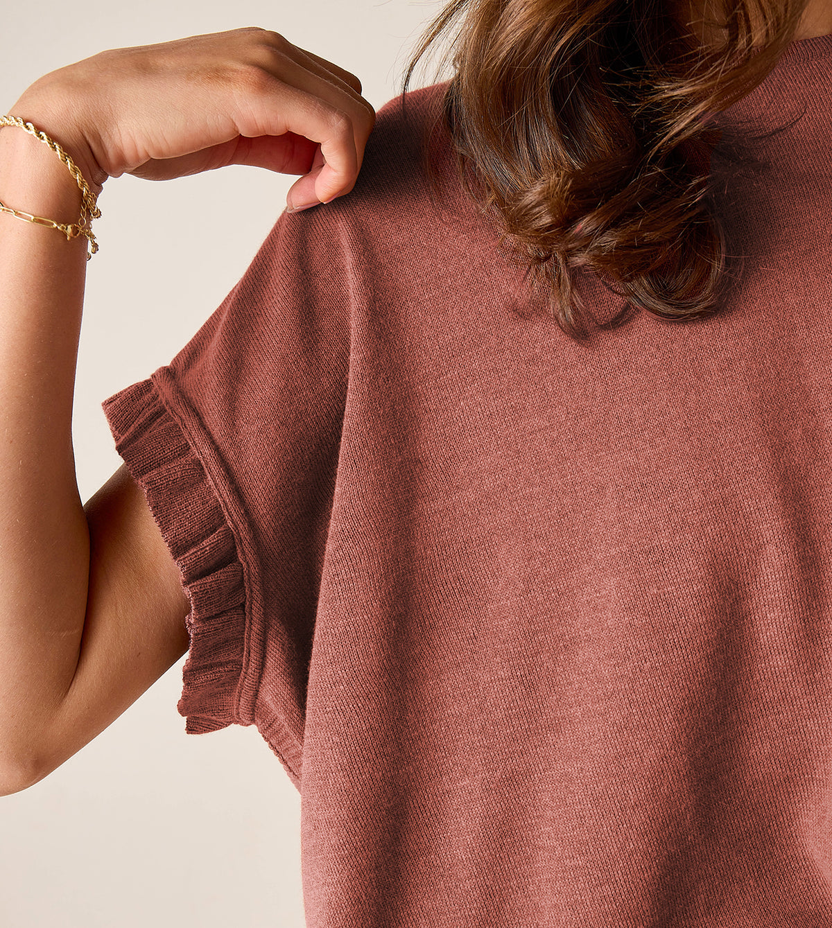 Terracotta pink knit top with ruffled sleeve detail
