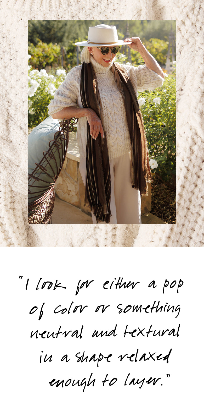 A woman wearing a wide-brimmed hat and sunglasses poses outdoors while draped in a long knit scarf. Below the image, a quote reads: "I look for either a pop of color or something neutral and textural in a shape relaxed enough to layer."