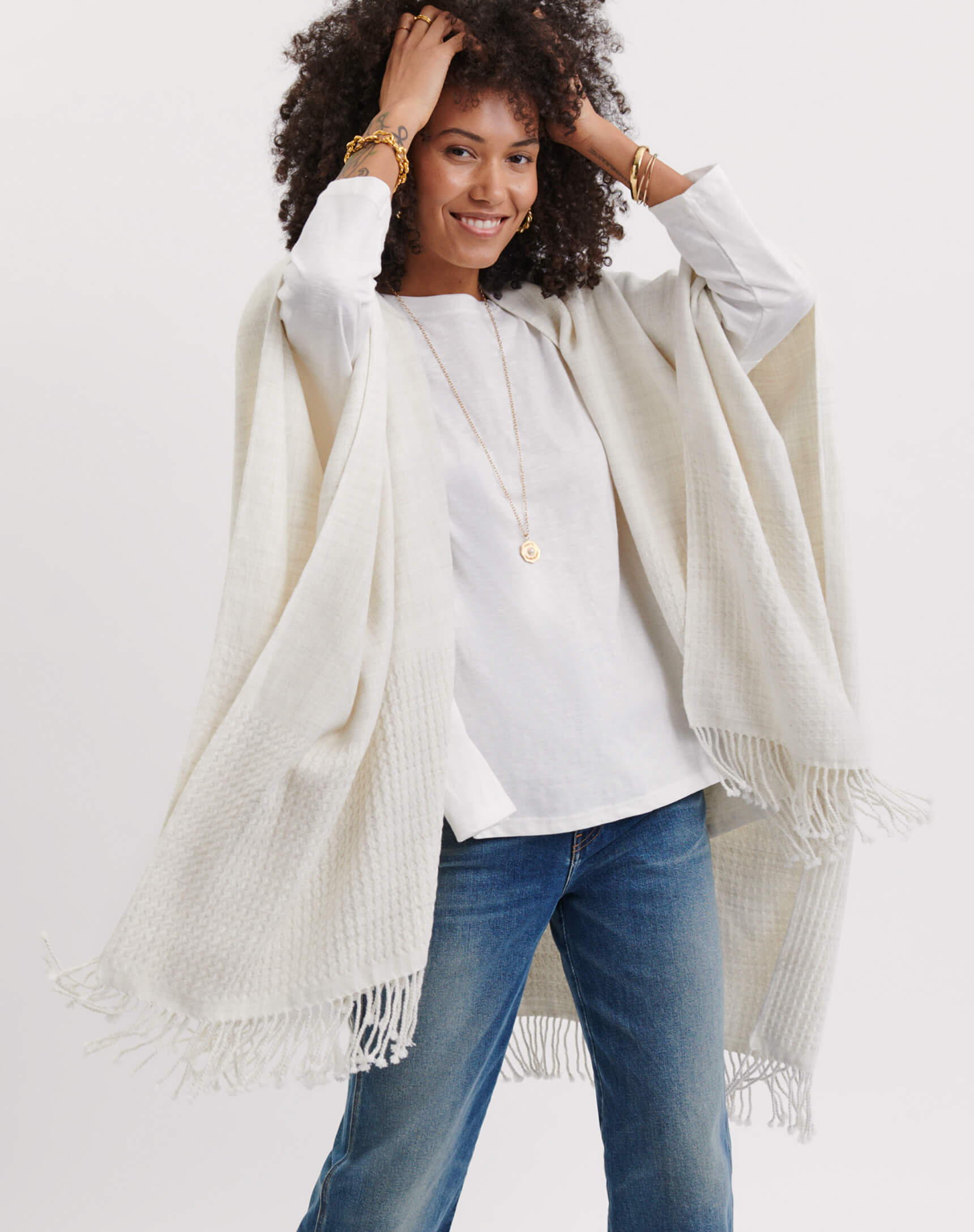 MERSEA women's travel-friendly off-white oversized knit wrap with fringed edges.