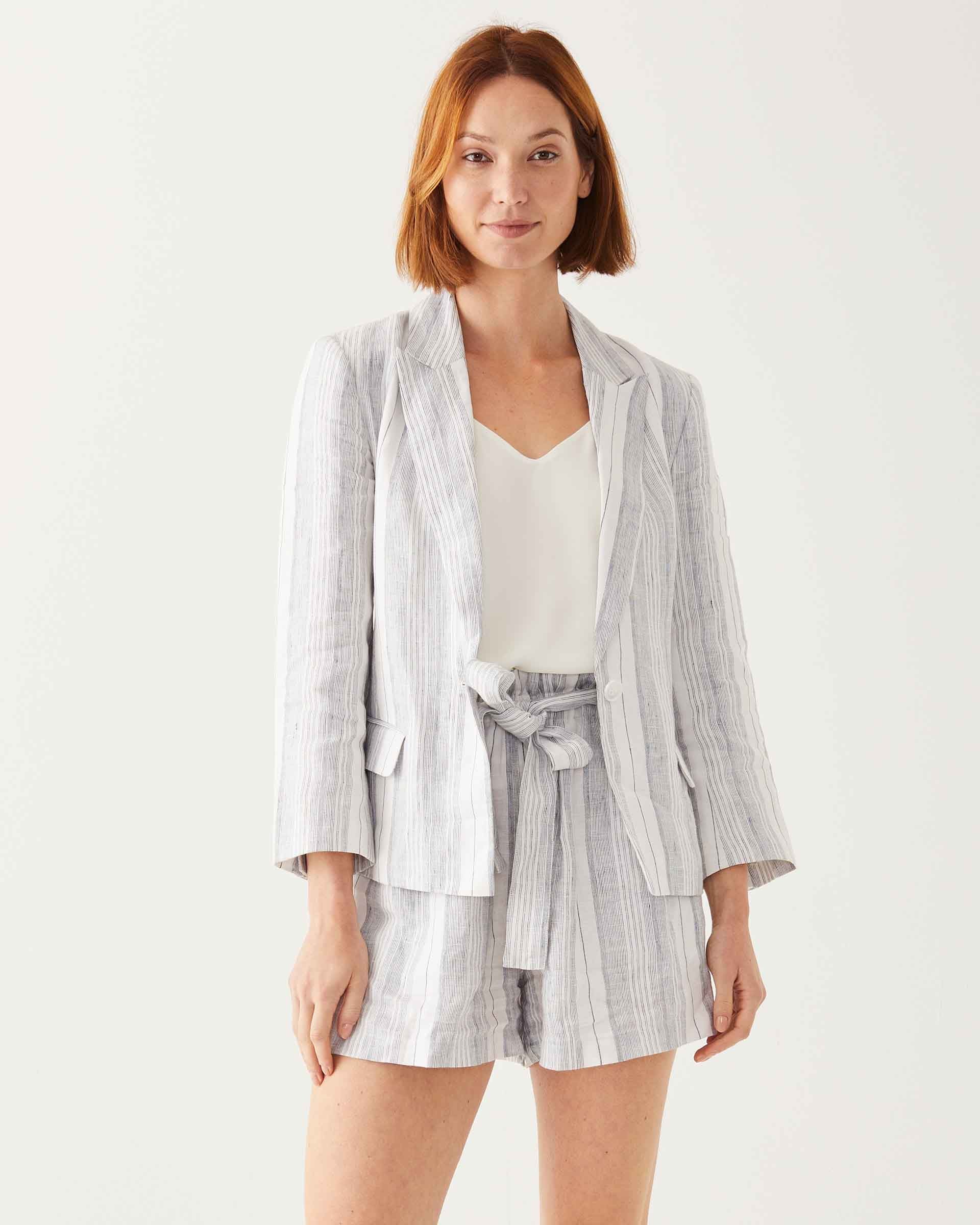 close up of female wearing navy striped white linen blazer and matching shorts on white background