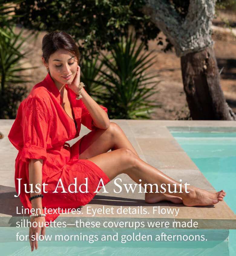 Just Add a Swimsuit - Linen textures. Eyelet details. Flowy silhouettes-these coverups were made for slow mornings and golden afternoons. - Image of a woman sitting by a pool wearing a red button up tunic coverup with flower embroidery and long sleeves.