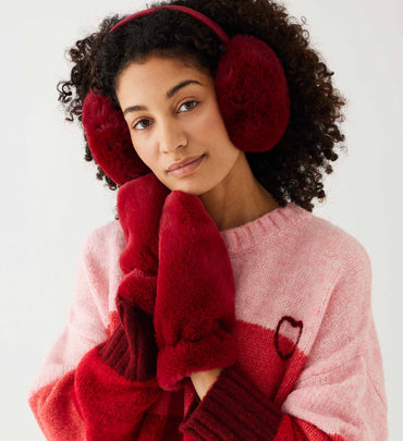female wearing red faux fur scarf with matching gloves and earmuffs on a white background