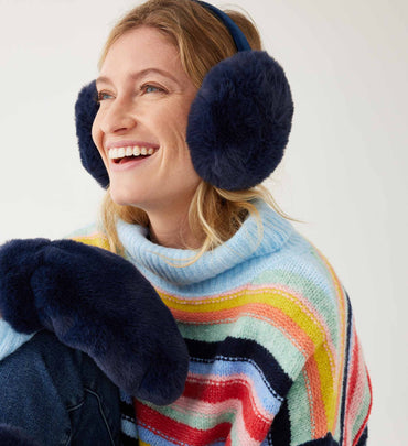 female wearing navy earmuffs and matching gloves with a striped sweater on a white background