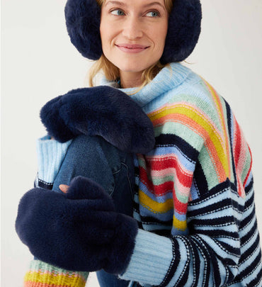 female wearing navy earmuffs and matching gloves with a striped sweater sitting on white background