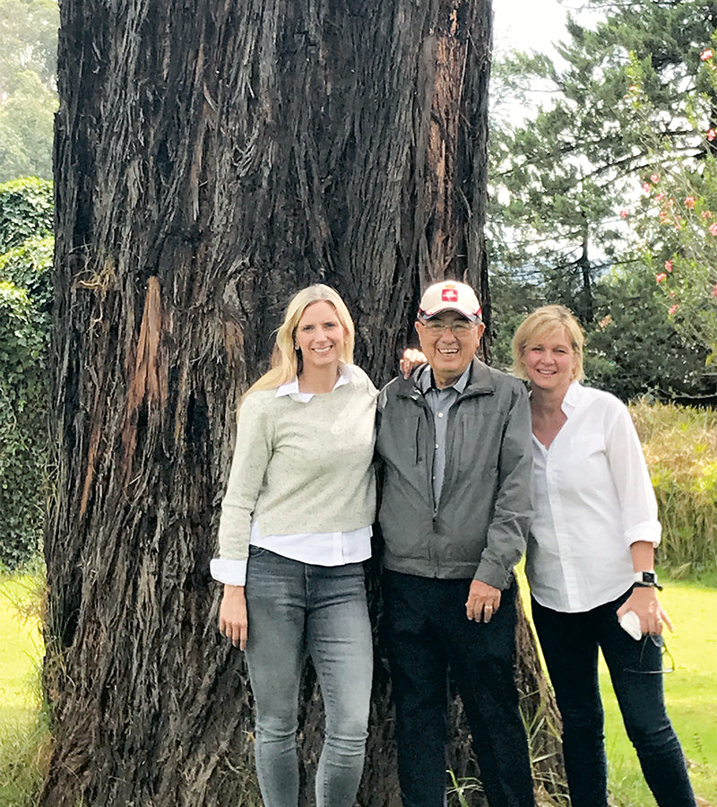 Our founders Mel & Lina standing with the factory owner in Ecuador