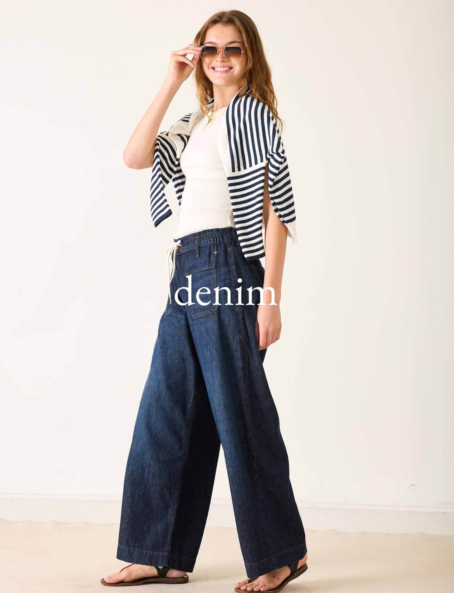 White top and navy striped wrap over wide-leg denim pants. Text: denim