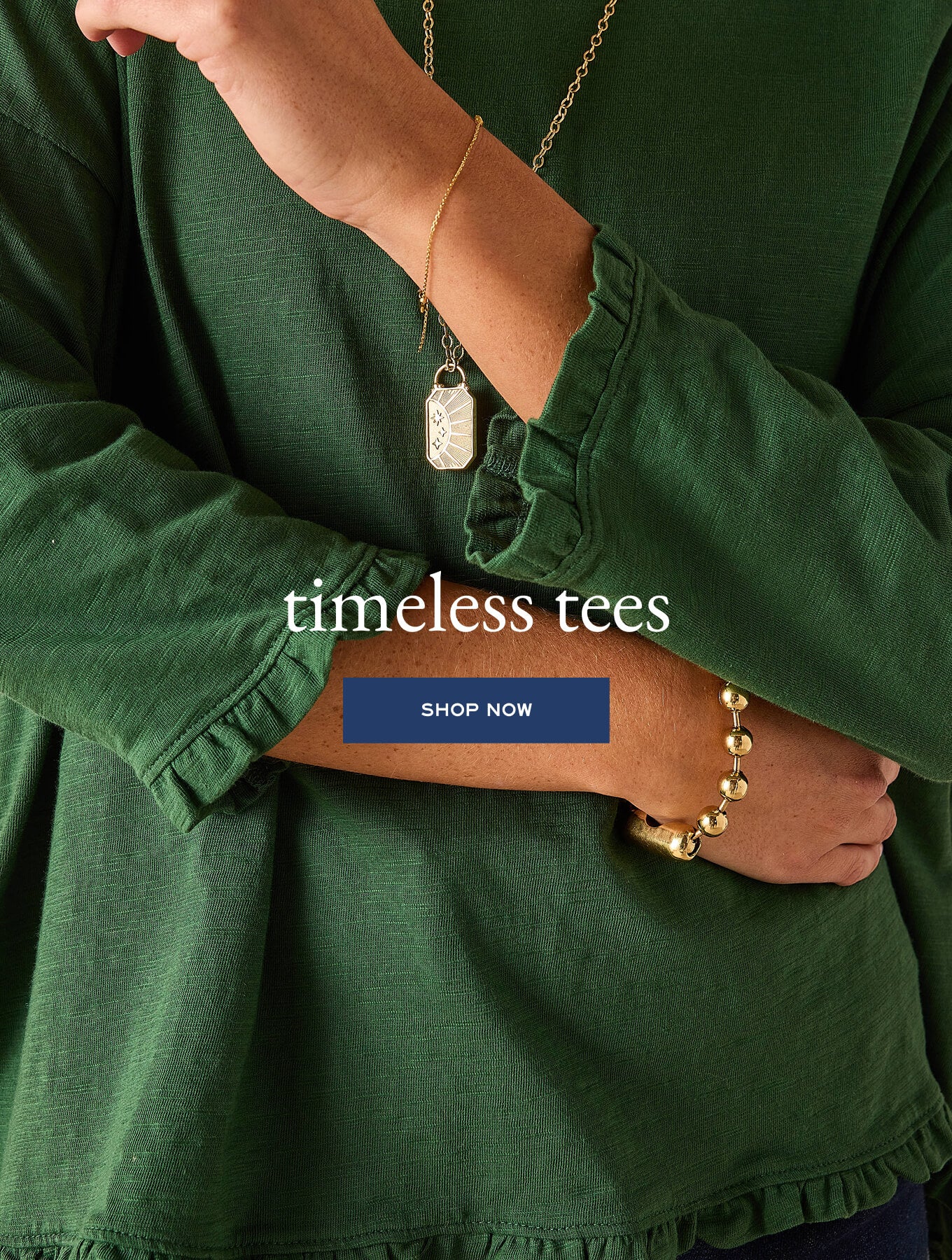 Dark green gathered tee with ruffle detail on the sleeve. Text: timeless tees SHOP NOW