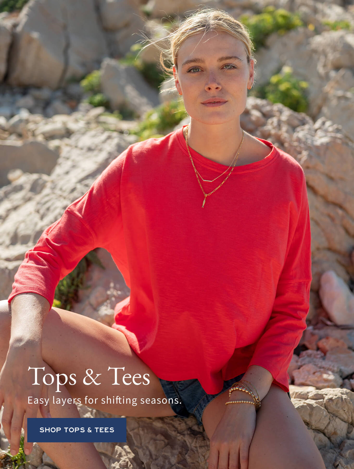 Promotional banner for tops and tees. Text: 'Tops & Tees. Easy layers for shifting seasons. SHOP TOPS & TEES'