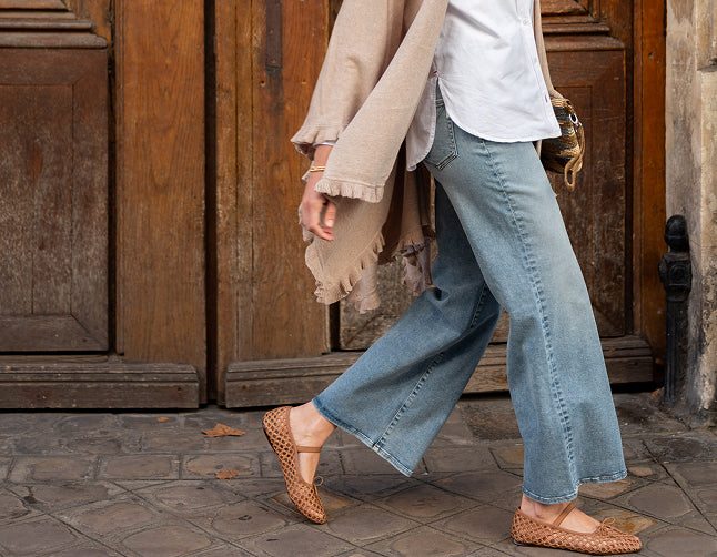Image of a woman wearing a pair of light blue wide leg jeans