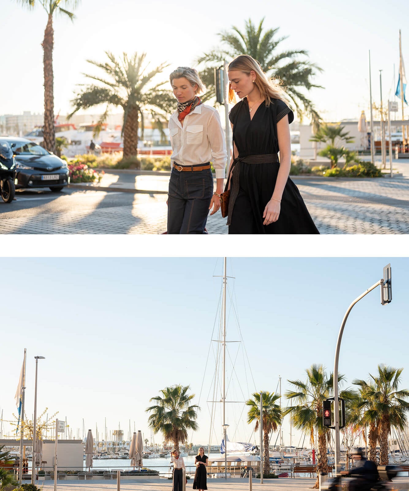 Two women stand and talk in a coastal town with palm trees and sailboats. The first woman wears a light-colored button-down shirt and a silk scarf; the second woman wears a black dress.