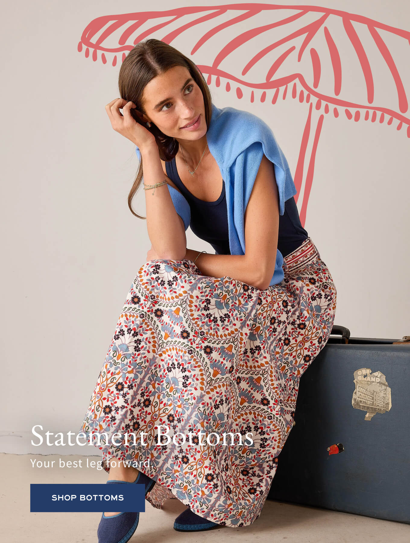 Floral print maxi skirt paired with a navy top and light blue knit wrap.