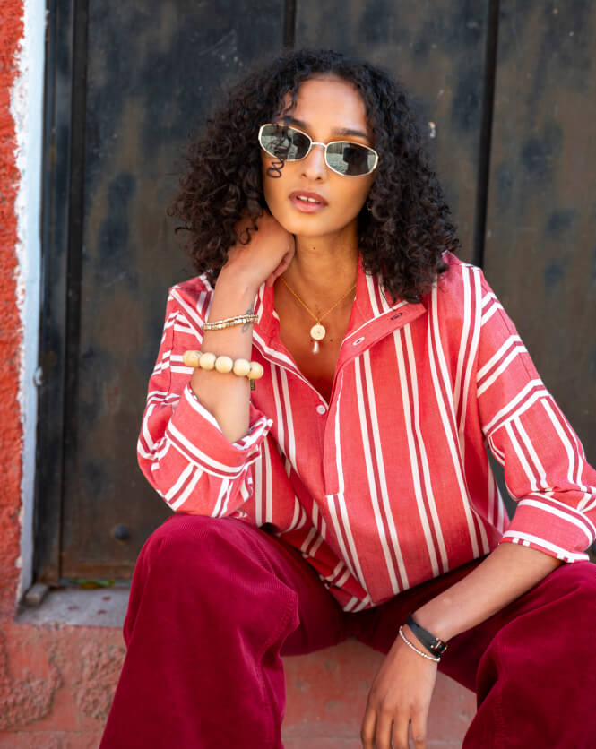 Image of a woman wearing a red and white striped collared top