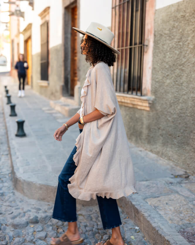 Image of a woman wearing a tan cotton cashmere kimono with ruffle details