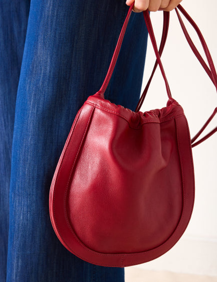 Close up image of a red leather bag