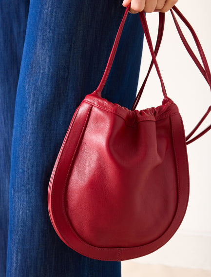Close up image of a red leather bag
