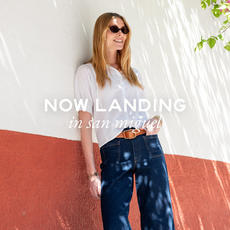 Now Landing in San Miguel - Image of a woman wearing a white button up top with short sleeves and puff sleeves