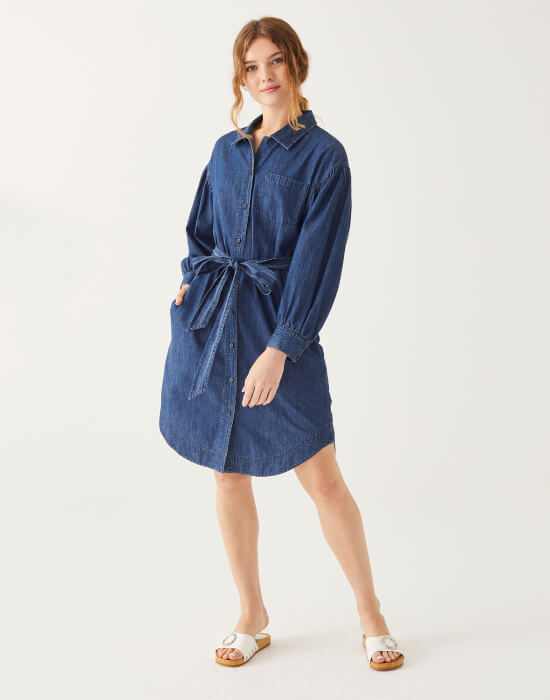 female wearing chambray collared button down dress with the front tied on white background