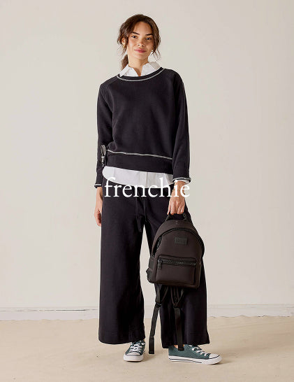 Frenchie - Image of a woman wearing a black French terry travel set