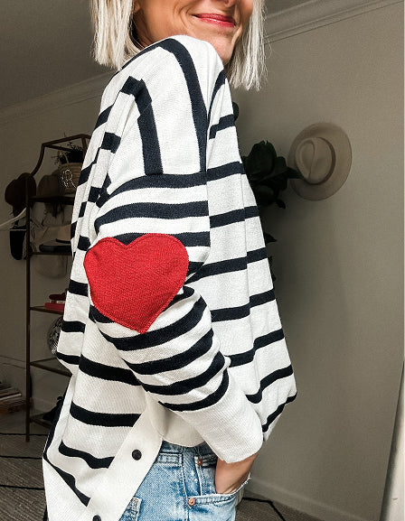 MERSEA ladies' travel-ready oversized knit sweater in black and white stripes featuring a heart-shaped pocket detail.