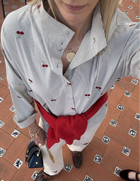 MERSEA women's travel-friendly white button-down shirt with thin blue stripes and small red berry accents.