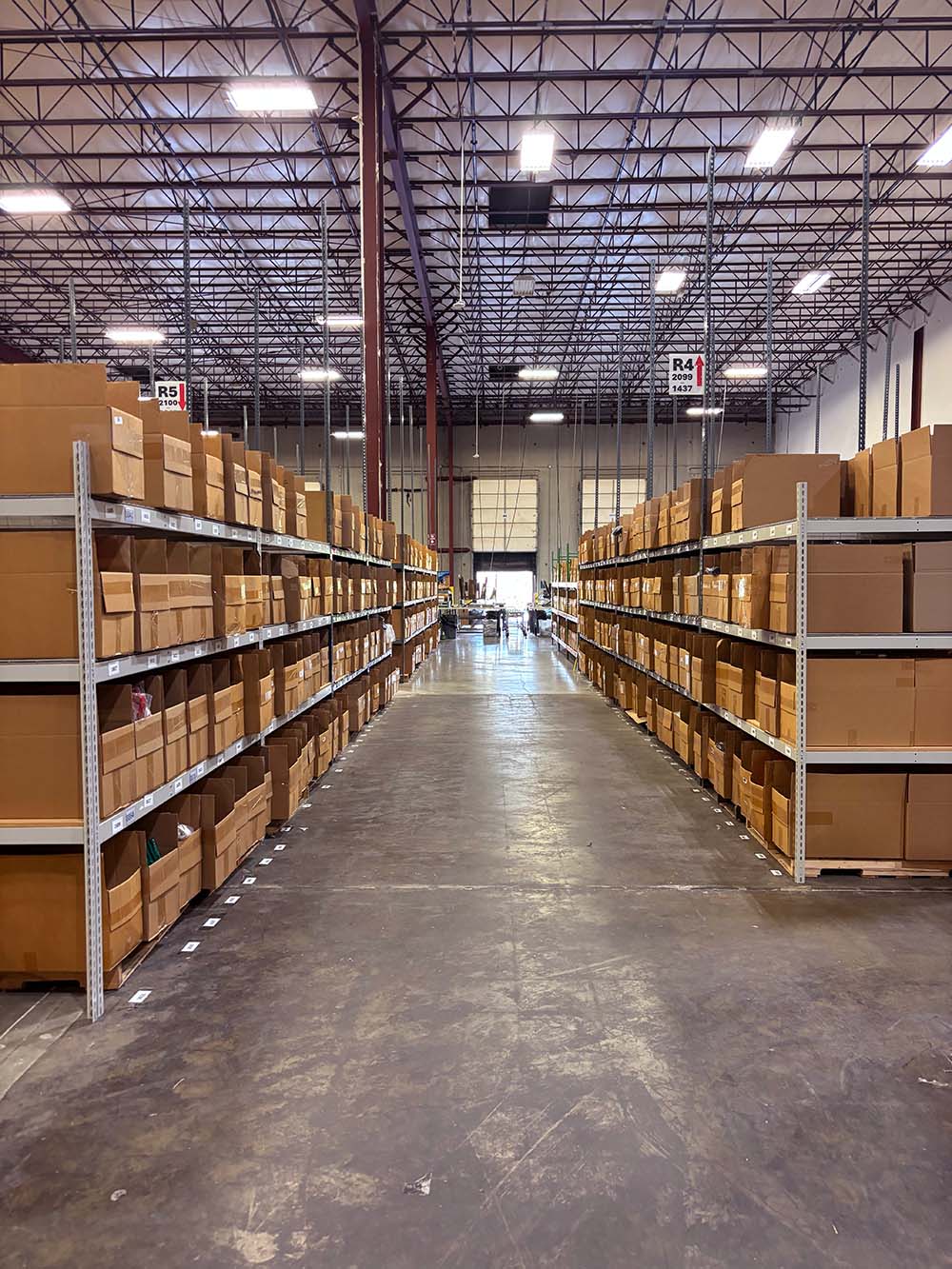 Warehouse interior with shelves stocked with cardboard boxes