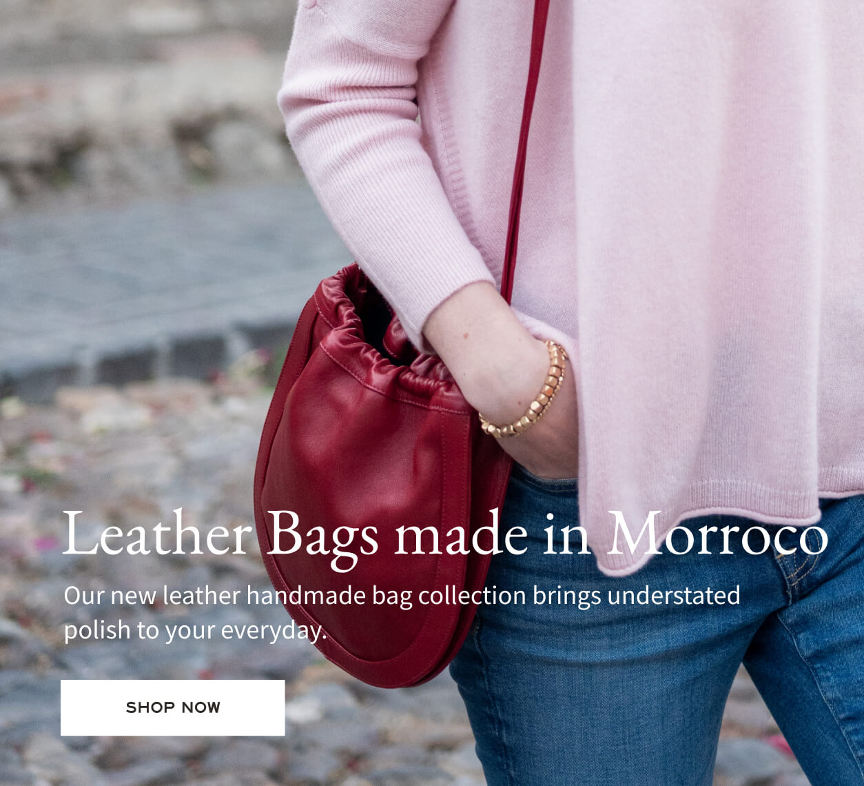 Person holding a red leather bag with text about Moroccan leather bags.